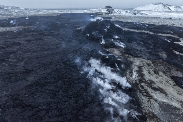 A view of the still steaming fissure from above, in Grindavik on Iceland's Reykjanes Peninsula, Thursday, Dec. 21, 2023. (AP Photo/Marco Di Marco)