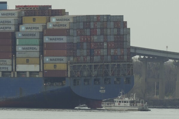 A container ship rests against wreckage of the Francis Scott Key Bridge on Tuesday, March 26, 2024, as seen from Dundalk, Md. (AP Photo/Matt Rourke)