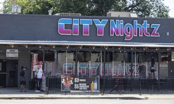 Two security guards hurt after man opens fire with a rifle outside strip  club