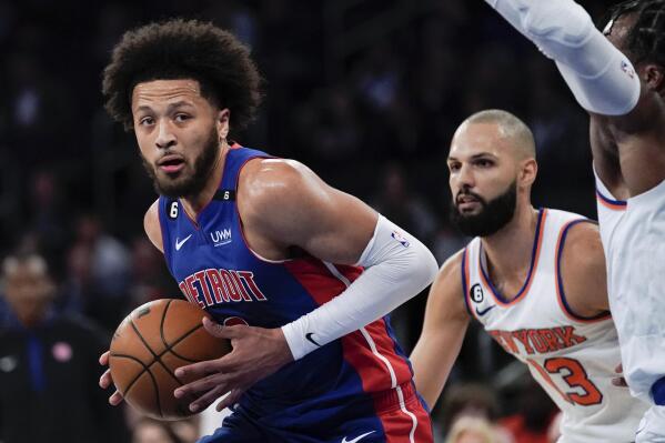 Detroit Pistons guard Cade Cunningham, left, is defended by New York Knicks' Evan Fournier during the first half of a preseason NBA basketball game Tuesday, Oct. 4, 2022, in New York. (AP Photo/Julia Nikhinson)