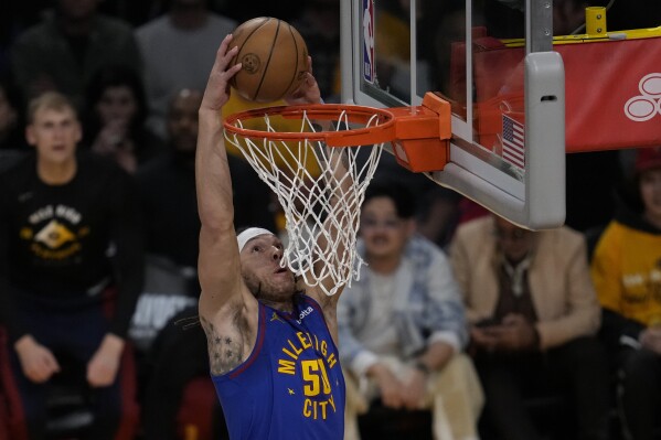 Denver Nuggets forward Aaron Gordon (50) dunks during the first half of Game 3 of an NBA basketball first-round playoff series against the Los Angeles Lakers in Los Angeles, Thursday, April 25, 2024. (AP Photo/Ashley Landis)
