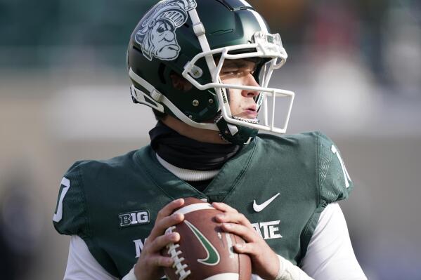 FILE - Michigan State quarterback Payton Thorne warms up before the first half of an NCAA college football game against Indiana, Saturday, Nov. 19, 2022, in East Lansing, Mich. Scouting and recruiting players in the NCAA transfer portal has become a vital part of building a college football program. And the process moves fast. To sift through a mountain of names, NFL-style personnel departments are using data and statistics from online analytics companies to more efficiently identify players who can help their teams. (AP Photo/Carlos Osorio, File)