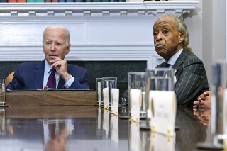FILE - President Joe Biden, left, and the Rev. Al Sharpton attend a meeting in the Roosevelt Room of the White House in Washington, Aug. 28, 2023. Organizers of Sharpton's annual National Action Network Convention announced Thursday, April 11, 2024, that Biden will give a live virtual keynote address to a racial justice conference in New York City on Friday. (AP Photo/Susan Walsh, File)