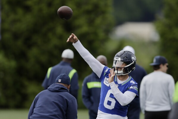 Seattle Seahawks quarterback Sam Howell throws a pass during an NFL football practice, Wednesday, May 22, 2024, in Renton, Wash. (AP Photo/ John Froschauer)