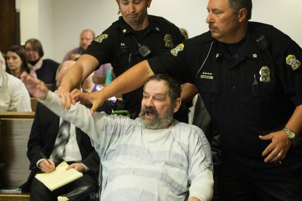 FILE - In this Nov. 10, 2015, file photo, Frazier Glenn Miller Jr., convicted of capital murder, attempted murder and other charges, gestures as Johnson County deputies remove Miller from the courtroom during the sentencing phase of his trial at the Johnson County District Court in Olathe, Kan. Miller, who fatally shot three people at Jewish sites in Kansas has died in prison, Monday, May 3, 2021, at the El Dorado Correctional Facility. (Joe Ledford/The Kansas City Star via AP, Pool, File)