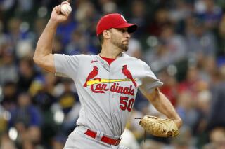 St. Louis Cardinals starting pitcher Adam Wainwright strikes out Milwaukee Brewers' Luis Urias for his career 2,000th strikeout during the fourth inning of a baseball game Thursday, Sept. 23, 2021, in Milwaukee. (AP Photo/Jeffrey Phelps)