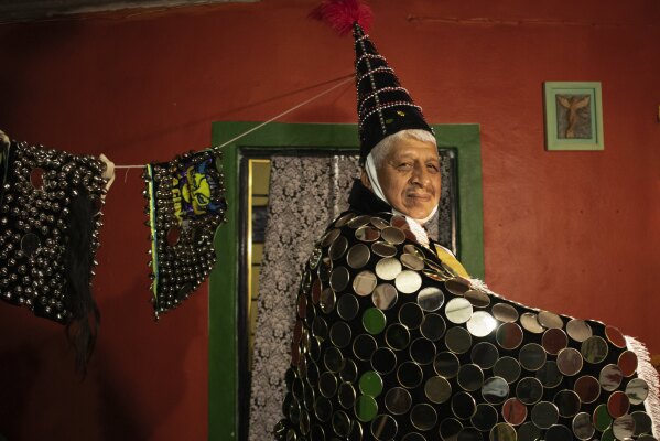 Efrain Garcia poses wearing his mirrors costume, at his home in San Jose, Mexico, Monday, Oct. 30, 2023. Mexicans in the Oaxacan town celebrate the traditional Muerteada, a theatrical recreation that is performed through the night of November 1 until the early morning of the following day, with dances and music parading through the streets, while telling the story of how a deceased person is resurrected with the help of a priest, a doctor and a spiritist. (AP Photo/Maria Alferez)