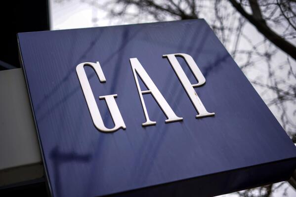FILE - A sign for the GAP is seen on a storefront in Pittsburgh on Wednesday, Jan. 12, 2022. Gap is slashing 500 corporate jobs in San Francisco and New York as it looks to reduce expenses amid languishing sales, a company spokesperson confirmed on Tuesday, Sept. 20, 2022. (AP Photo/Gene J. Puskar, File)
