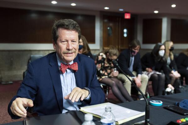 FILE - Dr. Robert Califf gathers his documents as the Senate Committee on Health, Education, Labor and Pension adjourn a hearing on the nomination of Califf to be Commissioner of Food and Drug Administration on Capitol Hill in Washington, on Dec. 14, 2021. (AP Photo/Manuel Balce Ceneta, File)