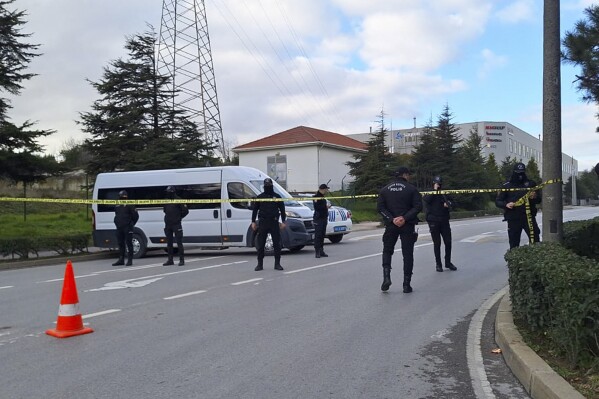 Police officers cordon off the area outside the Procter & Gamble factory near Gebze, northwest Turkey, Thursday, Feb. 1, 2024. Two gunmen took hostages at a factory owned by U.S. company Procter & Gamble in northwest Turkey on Thursday, according to media reports, apparently in protest of the Israel-Hamas war in Gaza. (Dia Images via AP)
