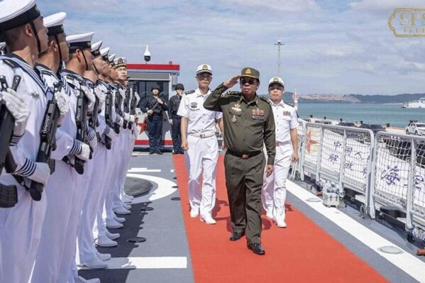 In this photo released by the official Facebook page of the Ream Naval Base, former Cambodian Defense Minister Tea Banh, second from right, reviews navy members before a training at Ream Naval Base in Sihanoukville, southwestern of Phnom Penh, Cambodia, Sunday, Dec. 3, 2023. (Ream Naval Base's Facebook page via AP)