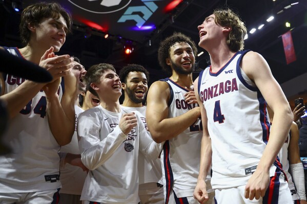 Gonzaga players celebrate after defeating San Francisco in an NCAA college basketball game in the semifinals of the West Coast Conference men's tournament Monday, March 11, 2024, in Las Vegas. (AP Photo/Ellen Schmidt)