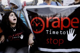 In this June 14, 2014 file photo, Egyptian women shout slogans and hold banners during a protest against sexual harassment in Cairo, Egypt. An announcement last month that Egyptian authorities would investigate an alleged 2014 gan rape of a 17-year old girl at a Cairo hotel was welcomed as a rare moment of triumph by rights activists who now fear the government is trying to discourage victims and witnesses from speaking out. (AP Photo/Amr Nabil, File)