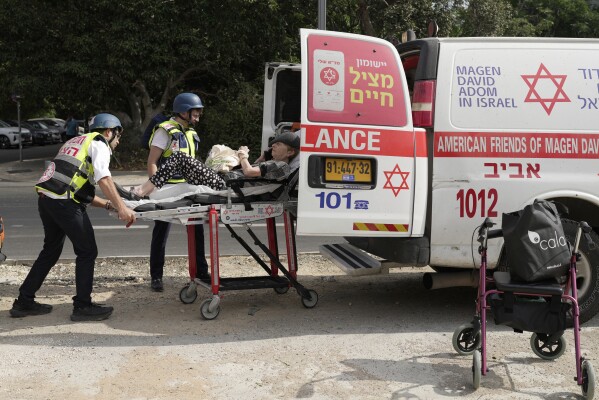 Medics evacuate a woman injured in an Iranian missile strike in Tel Aviv, Israel, Sunday, June 22, 2025. (AP Photo/Bernat Armangue)