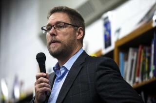 In this Oct. 16, 2019 photo, Des Moines Public Schools Superintendent Tom Ahart speaks to students about the By Degrees foundation starting college savings accounts for students at Harding Middle School in Des Moines, Iowa. Like superintendents across the country, the leader of Iowa’s largest school system has faced plenty of criticism as he attempted to educate children in the past year while also keeping them safe during the coronavirus pandemic. But as pressure eases in many districts thanks to falling infection rates, Ahart is facing more uncertainty. (Kelsey Kremer/The Des Moines Register via AP)