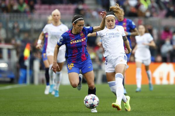 FILE - Barcelona's Aitana Bonmatí, left, and Real Madrid's Athenea del Castillo fight for the ball during the Women's Champions League quarter final, second leg soccer match between Barcelona and Real Madrid at Camp Nou stadium in Barcelona, Spain, Wednesday, March 30, 2022. Barcelona and Wolfsburg square off Saturday in the final of the Women’s Champions League. Both teams have something to prove. Barcelona was eyeing back-to-back titles last year before being upended by Lyon. Two-time champion Wolfsburg has lost the last three times it made it this far. (AP Photo/Joan Monfort, File)