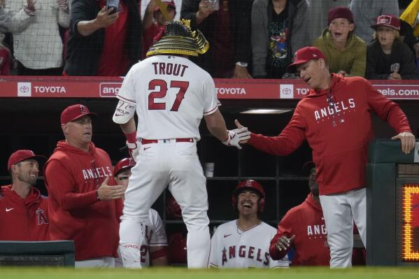 Shohei Ohtani of the Los Angeles Angels celebrates wearing a samurai  warrior helmet after hitting a two-run home run in the third inning of a  baseball game against the Seattle Mariners at