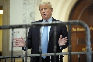 Former President Donald Trump speaks as he returns to the courtroom after the lunch break of his civil business fraud trial, Wednesday, Oct. 18, 2023, at New York Supreme Court in New York. (AP Photo/Seth Wenig)