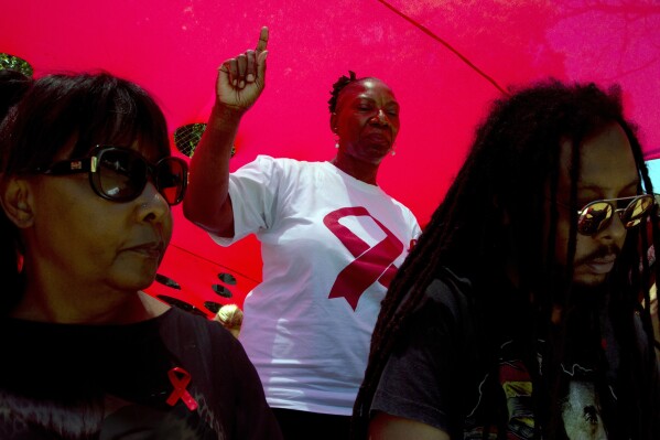 FILE - A woman dances as she listens to music while attending a World AIDS Day commemoration at Nkosi's Haven in Johannesburg on Nov. 30, 2019 on the eve of World AIDS Day. AIDS experts said Wednesday Nov. 29, 2023 that an African-based company will start producing vaginal rings that protect against HIV within the next few years, potentially offering millions of women across the continent a cheap way to reduce their risk. (AP Photo/Denis Farrell, File)