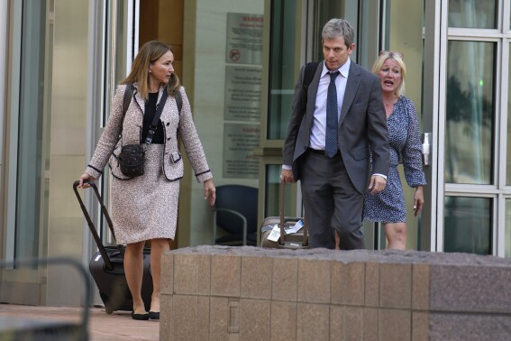 Margot Moss, left, and her co-counsel, David Oscar Markus, exit the federal courthouse after a judge handed down a sentence of life in prison and more than $15 million in penalties to their client, Larry Rudolph, the wealthy owner of a Pittsburgh-area dental franchise, for killing his wife at the end of an African safari in Zambia, during a sentencing hearing Monday, Aug. 21, 2023, in the federal courthouse in Denver. (AP Photo/David Zalubowski)
