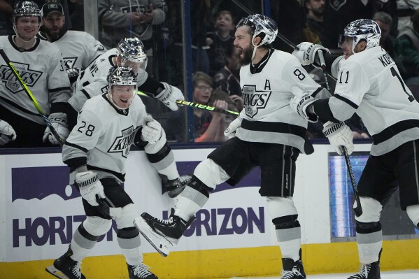 Los Angeles Kings' Drew Doughty (8) celebrates his game winning goal with teammates Jaret Anderson-Dolan (28) and Anze Kopitar (11) in overtime of an NHL hockey game against the Columbus Blue Jackets, Tuesday, Dec. 5, 2023, in Columbus, Ohio. (APPhoto/Sue Ogrocki)