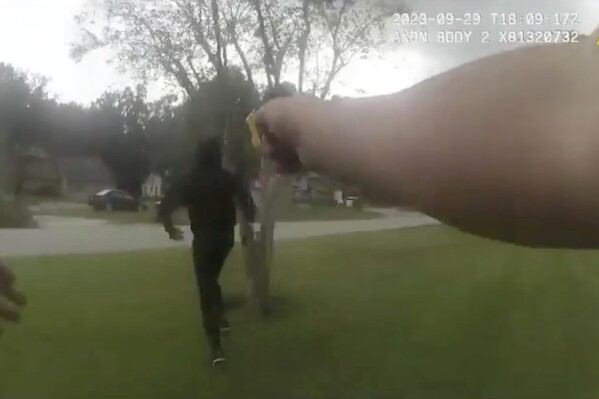 In this image taken from Jacksonville (Florida) Sheriff's Office body camera video, suspect Le'Keian Woods is hit with a Taser stun gun as he is chased by a Jacksonville police officer after fleeing a vehicle that was stopped during a traffic stop Friday, Sept. 29, 2023, in Fla. A Florida sheriff released the body camera video Monday, Oct. 2, that he says shows his officers were justified when they repeatedly punched, elbowed and kneed Woods, a drug suspect, who gave chase after being pulled over with two others during a traffic stop. (Jacksonville Sheriff's Office via AP)