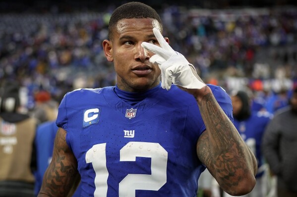 FILE - New York Giants tight end Darren Waller (12) gestures after an NFL football game against the Los Angeles Rams on Sunday, Dec. 31, 2023, in East Rutherford, N.J. Waller announced his retirement from playing football, Sunday, June 9, 2024, saying he “found a lot of joy” in the sport, but "the passion has slowly been fading.” (AP Photo/Bryan Woolston, File)