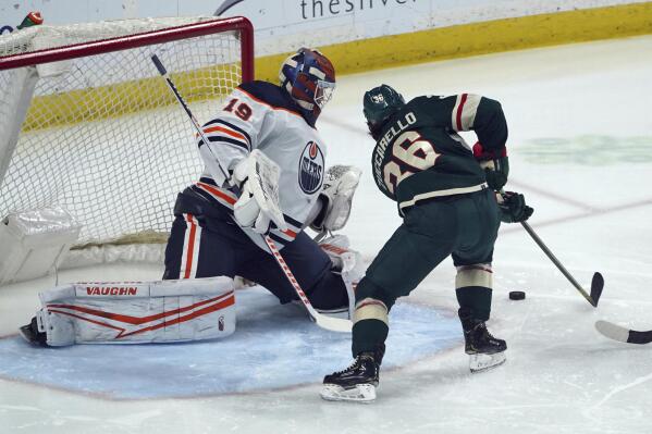Edmonton Oilers goalie Mikko Koskinen (19) defends as Minnesota Wild's Mats Zuccarello attempts a shot during the first period of an NHL hockey game Tuesday, April 12, 2022, in St. Paul, Minn. (AP Photo/Jim Mone)