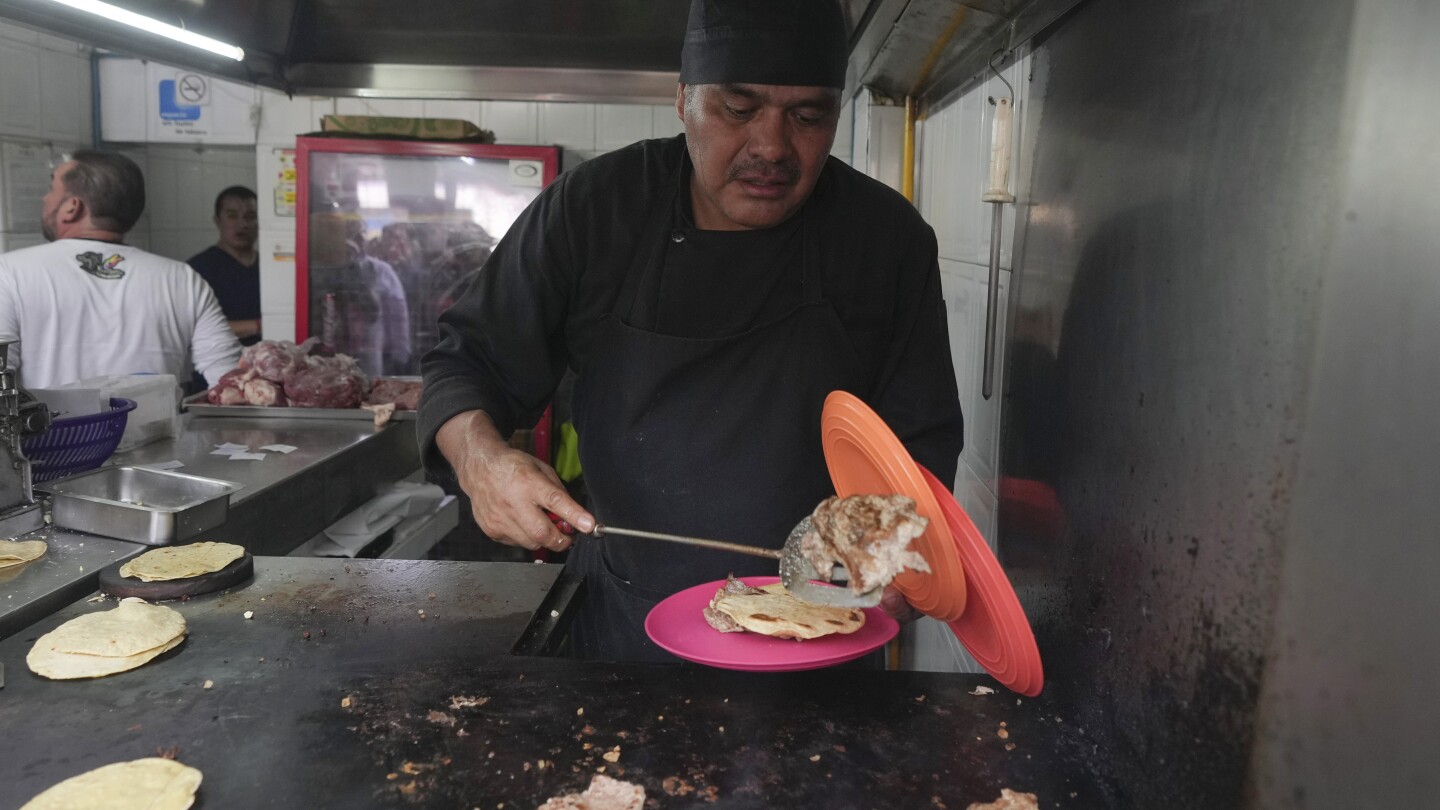 Create a website positioning title for this information article: 
                                        MEXICO CITY (AP) — Newly minted Michelin-starred chef Arturo Rivera Martínez stood over an insanely sizzling grill Wednesday on the first Mexican taco stand ever to get a coveted star from the French eating information, and did precisely the identical factor he’s been doing for 20 years: searing meat. Although Michelin representatives got here by Wednesday to current him with one of many firm’s heavy, full-sleeved, pristine white chef’s jackets, he didn’t put it on: On this tiny, 10-foot by 10-foot (3-meter by 3-meter) enterprise, the warmth makes the meat. And the warmth is intense.At Mexico Metropolis’s Tacos El Califa de León, within the scruffy-bohemian San Rafael neighborhood, there are solely 4 issues on the menu, all tacos, and all of which got here from some space round a cow’s rib, loin or fore shank.“The key is the simplicity of our taco. It has solely a tortilla, crimson or inexperienced sauce, and that’s it. That, and the standard of the meat,” mentioned Rivera Martínez. He’s additionally in all probability the one Michelin-starred chef who, when requested what beverage ought to accompany his meals, solutions “I like a Coke.”
    

It’s really extra difficult than that. El Califa de León is the one taco stand among the many 16 Mexican eating places given one star, in addition to two eateries that acquired two stars. Nearly all the remaining are fairly darn posh eateries (trace: lots of costly seafood served in fairly shells on bespoke plates). 



In reality, apart from maybe one avenue meals stand in Bangkok, El Califa de León might be the smallest restaurant ever to get a Michelin star: Half of the 100 square-foot (9.29 square-meter) house is taken up by a stable metal plate grill that’s hotter than the salsa.
    
The opposite half is filled with standing prospects clutching plastic plates and ladling salsa, and the feminine assistant who rolls out the rounds of tortilla dough consistently.In a manner, El Califa de León is a tribute to resistance to vary. It acquired there by doing precisely the identical 4 issues it has been doing since 1968.
    

1000’s of time a day, Rivera Martínez grabs a recent, thinly sliced fillet of beef from a stack and slaps it on the super-hot metal grill; it sizzles violently. He tosses a pinch of salt over it, squeezes half a lime on high, and grabs a gentle spherical of freshly rolled tortilla dough onto the stable steel slab to puff up. 
            
                
                    
    
    


    
        
    
        

    

    
        

    

    
        

    

    
        

    

    
        

    

    
        

    



    

    
        
            
                    A buyer finishes squeezing lime juice on his tacos on the Tacos El Califa de León stand, in Mexico Metropolis, Wednesday, Might 15, 2024. Tacos El Califa de León is the primary ever taco stand to obtain a Michelin star from the French eating information. (AP Picture/Fernando Llano)
                
            
        
    


                
            
        
         
            
                
                
    

    
        
    
        

    

    
        

    

    
        

    

    
        

    



    

    
        
            
                    A buyer flashes a thumbs up whereas consuming a taco from the Tacos El Califa de León taco stand, in Mexico Metropolis, Wednesday, Might 15, 2024. Tacos El Califa de León is the primary ever taco stand to obtain a Michelin star from the French eating information. (AP Picture/Fernando Llano)
                
            
        
    


    

    
        
    
        

    

    
        

    

    
        

    

    
        

    



    

    
        
            
                    An overhead view of the Tacos El Califa de León taco stand, in Mexico Metropolis, Wednesday, Might 15, 2024. Tacos El Califa de León is the primary ever taco stand to obtain a Michelin star from the French eating information. (AP Picture/Fernando Llano)
                
            
        
    


                
            
         
    After lower than a minute — he gained’t say precisely how lengthy as a result of “that’s a secret” — he flips the meat over with a spatula, flips the tortilla, and really shortly scoops the cooked, recent tortilla onto a plastic plate, locations the meat on high and calls out the client’s title who ordered it.Any sauces — fiery crimson or equally atomic inexperienced — are added by the client. There is no such thing as a place to take a seat and at some occasions of day, no place to face as a result of the sidewalk in entrance of the enterprise was taken over by avenue distributors hawking socks and batteries and cellular phone equipment years in the past. Not that you just actually would need to eat contained in the tiny taco restaurant. The warmth on a spring day is overwhelming.The warmth is without doubt one of the few secrets and techniques Rivera Martínez would share. The metal grill needs to be heated to an astounding 680 levels (360 Celsius). Requested the way it felt to get a Michelin star, he mentioned in traditional Mexico Metropolis slang, “está chido … está padre,” or “it’s neat, it’s cool.”
    

The costs are fairly excessive by Mexican requirements. A single, beneficiant however not enormous taco prices almost $5. However many shoppers are satisfied it’s the most effective, if not the most affordable, within the metropolis.
            
                
                    
    
    


    
        
    
        

    

    
        

    

    
        

    

    
        

    

    
        

    

    
        

    



    

    
        
            
                    Newly minted Michelin-starred chef Arturo Rivera Martínez prepares an order of tacos on the Tacos El Califa de León taco stand, in Mexico Metropolis, Wednesday, Might 15, 2024. Tacos El Califa de León is the primary ever taco stand to obtain a Michelin star from the French eating information. (AP Picture/Fernando Llano)
                
            
        
    


                
            
        
         
            
                
                
    

    
        
    
        

    

    
        

    

    
        

    

    
        

    



    

    
        
            
                    Prospects line as much as order on the Tacos El Califa de León taco stand, in Mexico Metropolis, Wednesday, Might 15, 2024. Tacos El Califa de León is the primary ever taco stand to obtain a Michelin star from the French eating information. (AP Picture/Fernando Llano)
                
            
        
    


    

    
        
    
        

    

    
        

    

    
        

    

    
        

    



    

    
        
            
                    A buyer holds his partially eaten taco on the Tacos El Califa de León taco stand, in Mexico Metropolis, Wednesday, Might 15, 2024. Tacos El Califa de León is the primary ever taco stand to obtain a Michelin star from the French eating information. (AP Picture/Fernando Llano)
                
            
        
    


                
            
         
    “It’s the standard of the meat,” mentioned Alberto Muñoz, who has been coming right here for about eight years. “I’ve by no means been dissatisfied. And now I’ll suggest it with much more motive, now that it has a star.”Muñoz’s son, Alan, who was ready for a beef taco alongside his father, famous “it is a historic day for Mexican delicacies, and we’re witnesses to it.” It truly is about not altering something — the freshness of the tortillas, the menu, the format of the restaurant. Proprietor Mario Hernández Alonso gained’t even reveal the place he buys his meat.
         
            
                
                
    

    
        
    
        

    

    
        

    

    
        

    

    
        

    



    

    
        
            
                    CORRECTS NAME – Mario Hernández Alonso, proprietor of Tacos El Califa de León, speaks with reporters in Mexico Metropolis, Wednesday, Might 15, 2024. Tacos El Califa de León is the primary ever taco stand to obtain a Michelin star from the French eating information. (AP Picture/Fernando Llano)
                
            
        
    


    

    
        
    
        

    

    
        

    

    
        

    

    
        

    



    

    
        
            
                    An worker tosses a tortilla on a griddle on the Tacos El Califa de León taco stand, in Mexico Metropolis, Wednesday, Might 15, 2024. Tacos El Califa de León is the primary ever taco stand to obtain a Michelin star from the French eating information. (AP Picture/Fernando Llano)
                
            
        
    


                
            
         
    Occasions have modified, although. Probably the most loyal buyer base for El Califa de León initially got here from politicians of the previous ruling PRI social gathering, whose headquarters is about 5 blocks away. However the social gathering misplaced the presidency in 2018 and has gone into a gradual decline, and now it’s uncommon to see anybody in a swimsuit right here.
    

And Hernández Alonso famous that his father Juan, who based the enterprise, by no means bothered to trademark the Califa title and so a well-funded, glossy taco chain has opened about 15 ethereal eating places in upscale neighborhoods below an identical title. Hernández Alonso has been toying with the thought of getting the enterprise on social media, however that’s as much as his grandkids.By legislation, following the coronavirus pandemic, Mexico Metropolis eating places have been allowed to open up street-side canopied seating areas. However El Califa de León doesn’t also have a sidewalk for patrons to eat on due to all the road distributors, so prospects now stand cheek-to jowl with show stands and plastic mannequins.
    

Requested if he would love them to make room for a street-side seating space, Hernández Alonso expressed an “if it ain’t broke, don’t repair it” angle. “Because the saying goes, why repair or change one thing that’s alright? You shouldn’t repair something,” he mentioned, motioning to the road distributors. “It’s the way in which God ordered issues, and you need to cope with it.”
                                    
  window.fbAsyncInit = function() {
      FB.init({
          
              appId : '870613919693099',
          
          xfbml : true,
          version : 'v2.9'
      });
  };

  (function(d, s, id){
     var js, fjs = d.getElementsByTagName(s)[0];
     if (d.getElementById(id)) {return;}
     js = d.createElement(s); js.id = id;
     js.src = "https://connect.facebook.net/en_US/sdk.js";
     fjs.parentNode.insertBefore(js, fjs);
   }(document, 'script', 'facebook-jssdk'));