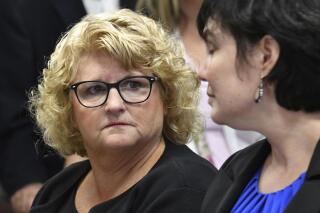 FILE - In this Sept. 27, 2018 file photo, Kathie Klages, left, former MSU women's gymnastics coach, looks at her attorney, Mary Chartier in court in Lansing, Mich. The Michigan Supreme Court turned down an appeal Wednesday, Sept. 21, 2022, and won't reinstate the conviction of Klages, a retired Michigan State University gymnastics coach who was accused of lying to investigators about campus sports doctor Larry Nassar. (Dale G.Young/Detroit News via AP)