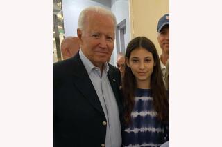 In this photo provided by a family member, 12-year-old Elisheva Cohen poses with President Joe Biden, Thursday, July 1, 2021, in Surfside, Fla., as the president and first lady visited the community devastated by the fatal collapse of the 12-story Champlain Towers South beachfront condominium a week earlier. (Contributed Photo via AP)