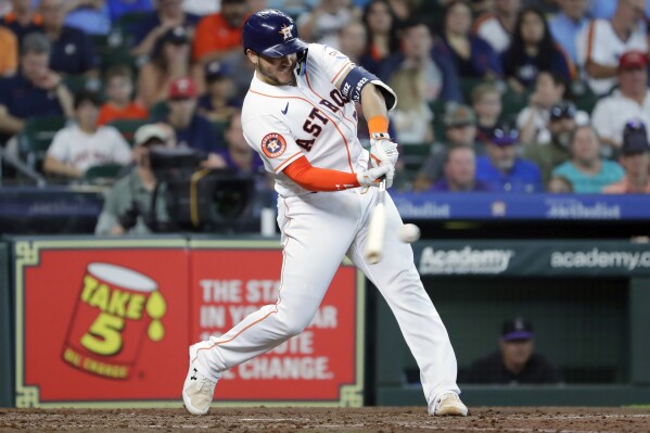 Houston Astros' Yainer Diaz celebrates in the dugout after hitting