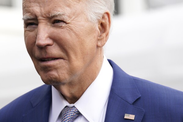 President Joe Biden speaks to the media before boarding Marine One on the South Lawn of the White House, Thursday, Jan. 18, 2024, in Washington. Biden is traveling to North Carolina to highlight $82 million in new investments that would connect 16,000 households and businesses to high-speed internet. (AP Photo/Yuri Gripas)