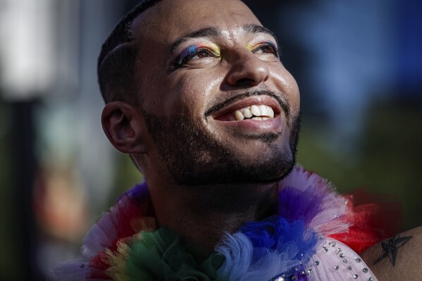 A reveler smiles during the annual Gay Pride Parade in Sao Paulo, Brazil, Sunday, June 11, 2023. (AP Photo/Tuane Fernandes)