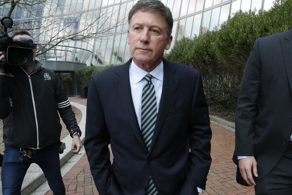
              FILE - In this April 3, 2019 file photo, Bruce Isackson departs federal court in Boston after facing charges in a nationwide college admissions bribery scandal. In a court filing on Monday, April 8, 2019, Isackson agreed to plead guilty in the cheating scam. (AP Photos/Michael Dwyer, File)
            