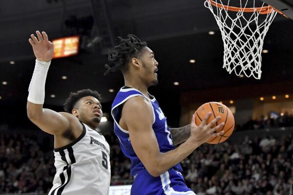 Providence forward Ed Croswell (5) moves in to block a shot by Seton Hall guard Dre Davis (14) during the first half of an NCAA college basketball game Saturday, March 4, 2023, in Providence, R.I. (AP Photo/Mark Stockwell)