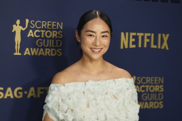 Greta Lee arrives at the 30th annual Screen Actors Guild Awards on Saturday, Feb. 24, 2024, at the Shrine Auditorium in Los Angeles. (Photo by Jordan Strauss/Invision/AP)