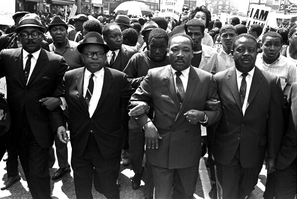 The Rev. Ralph Abernathy, right, and Bishop Julian Smith, left, flank Dr. Martin Luther King, Jr., during a civil rights march in Memphis, Tenn., March 28, 1968. (AP Photo/Jack Thornell, File)