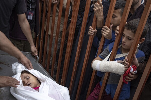 Palestinians mourn their relatives killed in an Israeli bombardment of the Gaza Strip, at the hospital in Khan Younis, Tuesday, Nov. 14, 2023. (AP Photo/Fatima Shbair)