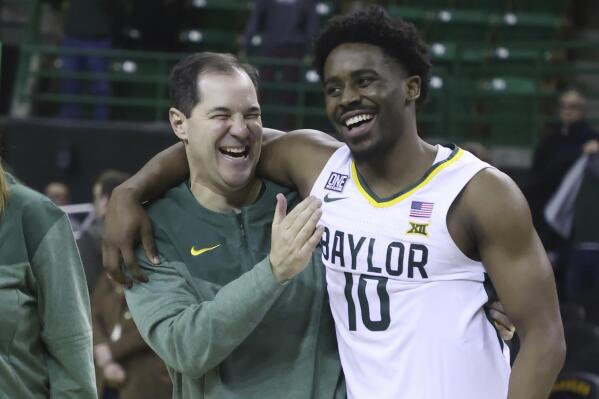 Baylor head coach Scott Drew shares a moment with Baylor guard Adam Flagler (10) after his 400th win over Northern Colorado after an NCAA college basketball game, Monday, Nov. 14, 2022, in Waco, Texas. (AP Photo/Rod Aydelotte)