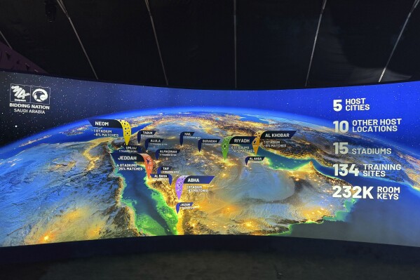 A map at the Saudi Arabia World Cup bid exhibition in Riyadh, Saudi Arabia, Wednesday Dec. 11, 2024, showing the proposed host cities and venues for the 2034 World Cup. (AP Photo/Baraa Anwer)