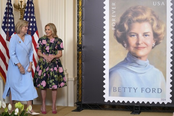 First lady Jill Biden, right, and Susan Ford Bales, daughter of former first lady Betty Ford, stand in the East Room of the White House in Washington, Wednesday, March 6, 2024, during an unveiling of a new U.S. Postal Service stamp honoring former first lady Betty Ford. (AP Photo/Susan Walsh)