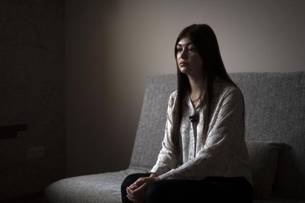 Alina Kapatsyna sits in a house in Dnipro, Ukraine, Friday, Jan. 6, 2023. Men in military uniforms took her mother 45-year-old Vita Hannych away from her house in eastern Ukraine in April. Since the war in Ukraine began, many civilians have been detained by Russian forces and are languishing in jails for months without charges as their relatives seek to find out what's happened to them. (AP Photo/Hanna Arhirova)