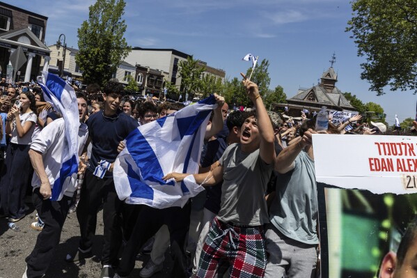 People gathered in Huyler Park celebrate the release of American hostage Edan Alexander from Hamas on Monday, May 12, 2025, in Tenafly, N.J. (AP Photo/Stefan Jeremiah)
