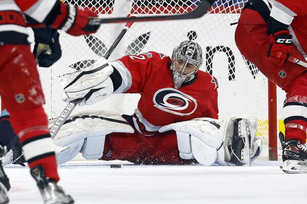Carolina Hurricanes goaltender Pyotr Kochetkov (52) gathers in the loose puck during the second period of an NHL hockey game against the Seattle Kraken in Raleigh, N.C., Thursday, Dec. 15, 2022. (AP Photo/Karl B DeBlaker)