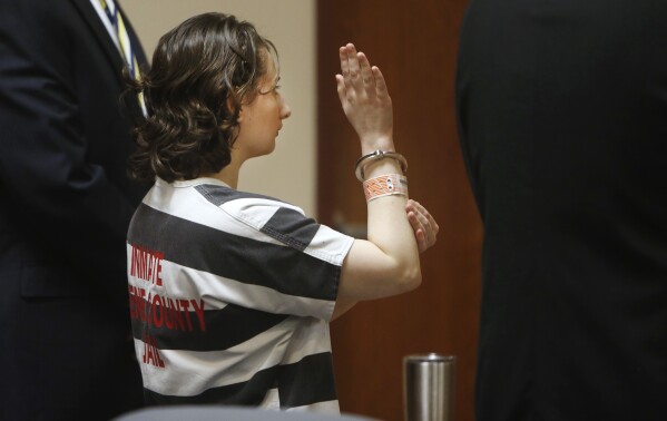 FILE - Gypsy Rose Blanchard raises her right hand and swears an oath while pleading guilty to murder in the second degree during her court appearance, July 5, 2016, in Springfield, Mo. Blanchard, the Missouri woman who admitted to convincing her online boyfriend to kill her abusive mother after being forced to pretend for years she was suffering from leukemia, muscular dystrophy and other serious illnesses, is set to be paroled Thursday, Dec. 28, 2023. (Andrew Jansen/The Springfield News-Leader via AP, File)