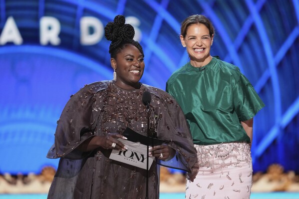 Danielle Brooks, left, and Katie Holmes present the award for best performance by an actor in a featured role in a play during the 78th Tony Awards on Sunday, June 8, 2025, at Radio City Music Hall in New York. (Photo by Charles Sykes/Invision/AP)