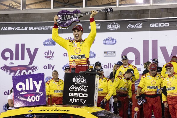 Joey Logano, top, celebrates after winning a NASCAR Cup Series auto race, Sunday, June 30, 2024, in Gladeville, Tenn. (AP Photo/Wade Payne)