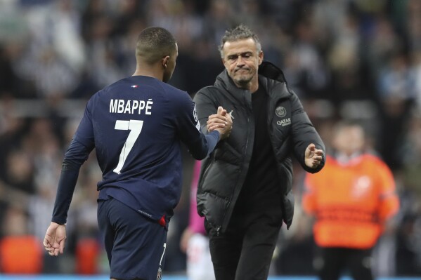 PSG's Kylian Mbappe, shakes hands with PSG's head coach Luis Enrique at the end of the Champions League group F soccer match between Newcastle and Paris Saint Germain at St. James' Park, Wednesday, Oct. 4, 2023, in Newcastle, England. (AP Photo/Scott Heppell)