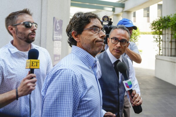 Dr. Mark Chavez, center, a physician from San Diego, who is charged in connection with actor Matthew Perry's death from an accidental ketamine overdose, arrives at the Roybal Federal Courthouse in Los Angeles, Friday, Aug. 30, 2024. (AP Photo/Damian Dovarganes)
